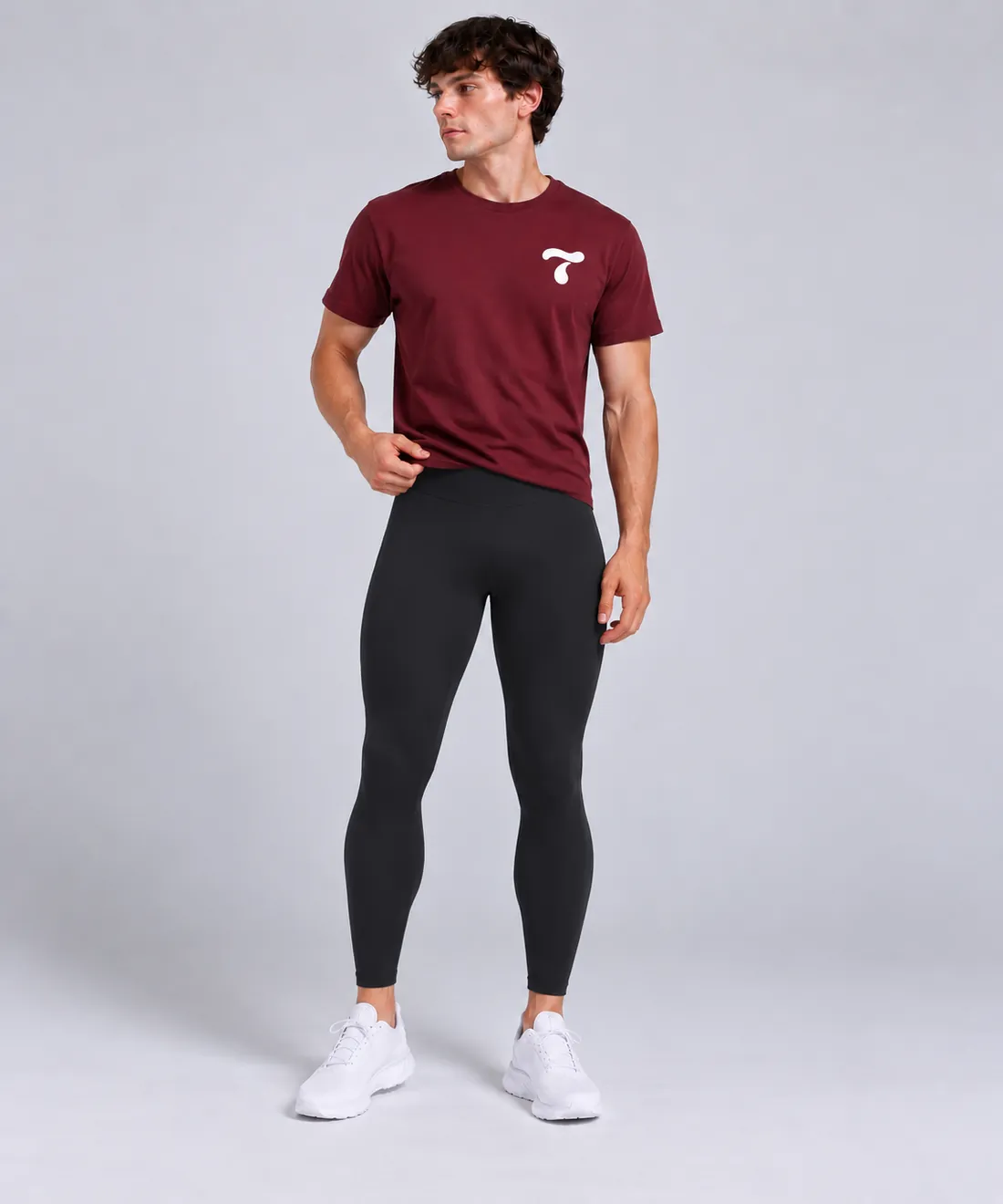 Man wearing black Torasca leggings with a burgundy t-shirt